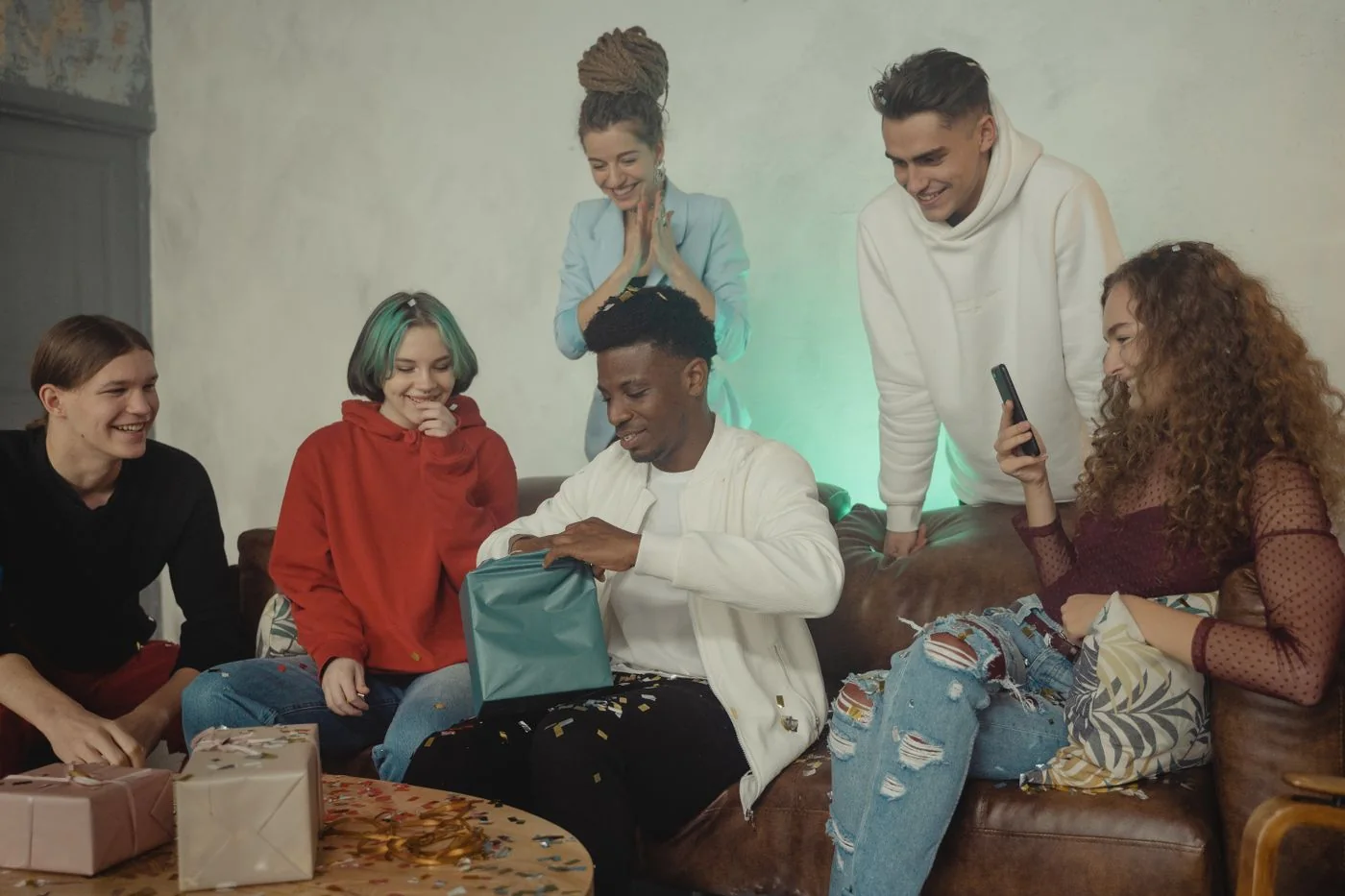 A group celebrating together as a gift is opened